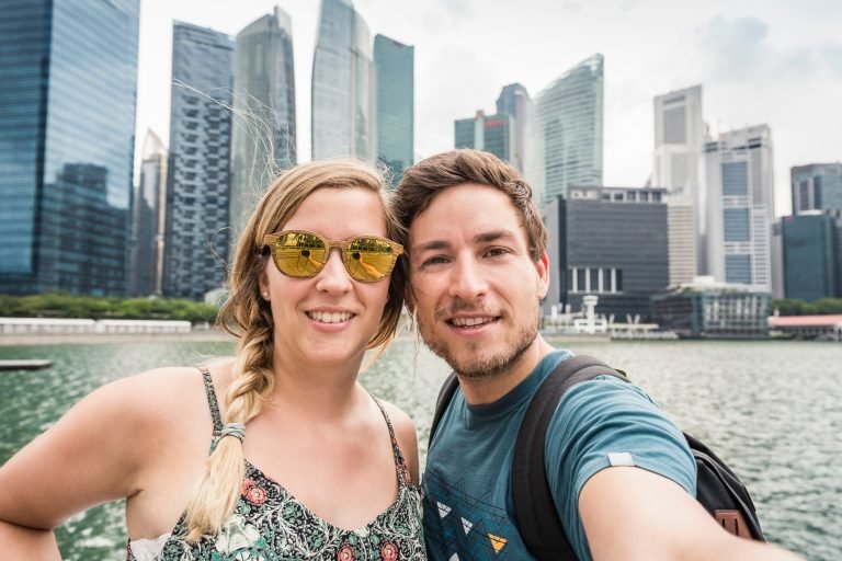 Tourists posing in front of Singapore skyline, Marina Bay